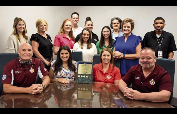 St. James Parish Finance Director Felix Boughton (seated on left) and St. James Parish President Pete Dufresne (seated far right) join the members of the Finance Department to celebrate receiving the Government Finance Officers Association (GFOA) Certific