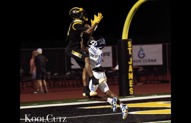 A St. James Wildcat receiver leaps to catch a touchdown pass against West St. John. The Wildcats dominated and shut out the Rams 53-0 to improve to 2-0 on the season. Photo by Oliver Hooker