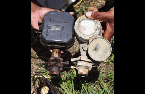 A new automated water meter (left) compared to the old meter previously used by St. James Parish.