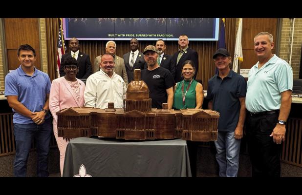 St. James Parish officials unveiled the model of the U. S. Capitol bonfire which will be built on the levee and burned on Christmas Eve, bringing unprecedented attention to St. James Parish during the holiday season. Also pictured are Kenny Berthelot, Tor