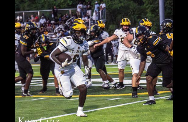 Wildcat running back Xavier Johnson picks up yards against East St. John. Johnson finished with 113-yards on 19 attempts and he had 101-yards receiving. Photo by Oliver Hooker
