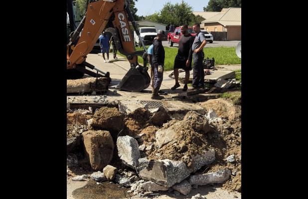 Lutcher Town workers bust up and dig up a section of Lionel Washington Street in order to reach a small puppy that managed to fall in a Town sewer clean-out pipe. Thankfully the dog was rescued, was uninjured, and only needed a good bath.