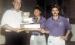 Joan and Tom Murray being presented the 1999 Division III State Championship trophy from a Louisiana High School Athletic Association representative. The Murrays coached and guided the LHS swimming team to six consecutive state championships from 1996 thr
