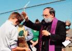 Bishop Michael Duca blesses the graves of the people buried in the sugarcane field. Bishop Joins Opposition Groups For All Saints Day Ceremony At Gravesite Located On Formosa Property