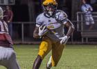 St. James Wildcat junior running back Xavier Johnson carries the ball last week against Dunham. Photo by Oliver Hooker