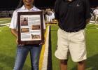 St. James High Principal Shawn Oubre and Hall of Fame committee member Boo Schexnayder accept the Hall of Fame plaque for the family of Rene Paille. Paille graduated in 1942 and was named to the All-State team five consecutive years.