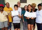 Pictured above holding certificates are Cypress Grove Montessori Academy student Devin Jenkins, who won 1st Place in the 2026 Tour of Restaurants T-Shirt design contest, and Gramercy Elementary student Paisley Aubert, who won 4th Place. The students were 