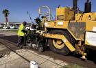 Workers use Louisiana Department of Transportation & Development ( LaDOTD) equipment to test whether a new road surface material called BioChar is compatible with the agency’s equipment designed to lay hot asphalt. The test was done at the foot of t Parish Once Again Selected As Test Site For New Road Surface Product