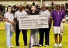 OxyChem presents a $15,000 check to representatives of the Lutcher-Cypress Grove-Romeville Athletic Hall of Fame last Friday at halftime.