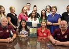 St. James Parish Finance Director Felix Boughton (seated on left) and St. James Parish President Pete Dufresne (seated far right) join the members of the Finance Department to celebrate receiving the Government Finance Officers Association (GFOA) Certific