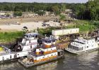 The Féte Dieu Du boat procession that traveled the Mississippi River totaled 14boats. Here we see some of them parked at American Commercial Barge Line’s dock just upriver from St. Michael Church. Photo by Drew Landry St. Micheal Church Shines As Host Of First Ever Féte Dieu Du Mississippi