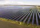 A photo of a large scale solar farm. A photo of a large scale solar farm.