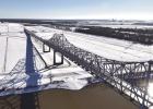 A drone shot of the Sunshine Bridge and surrounding sugar cane fields covered in snow. A drone shot of the Sunshine Bridge and surrounding sugar cane fields covered in snow.