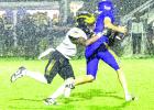 St. James Wildcat defender Jye Blain is not deterred by the rain as he wraps up and brings down the St. Charles Comet quarterback. The Wildcats beat the Comets 15-11 to improve their record to 3-1. Photo by Oliver Hooker Wildcats Hang On To Take Down Comets