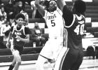 Lutcher Bulldog Junior Taj Anderson fends off a defender to take a shot. Photo by Wendy Neal Lutcher Bulldog Junior Taj Anderson fends off a defender to take a shot. Photo by Wendy Neal