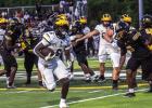 Wildcat running back Xavier Johnson picks up yards against East St. John. Johnson finished with 113-yards on 19 attempts and he had 101-yards receiving. Photo by Oliver Hooker