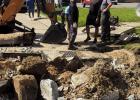 Lutcher Town workers bust up and dig up a section of Lionel Washington Street in order to reach a small puppy that managed to fall in a Town sewer clean-out pipe. Thankfully the dog was rescued, was uninjured, and only needed a good bath.