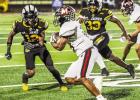 St. James Wildcat defenders Malik Harry (#12) and Ansyn Joseph (#33) pursue a Many ball carrier during last Friday’s 53-13 second round playoff win.