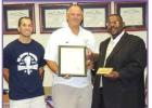 Lutcher head baseball coach Davey Clement, joined by his assistant coach Kyle Latiolais, is presented a resolution from former Lutcher Mayor Rowdy Scott congratulating the 2013 Bulldogs for winning the Class 4A State Championship. Article Image Alt Text