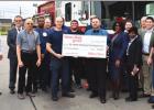 Gramercy Winn-Dixie store Manager Barrette Trosclair (bow tie) presents a $1,000 check to the St. James Parish Volunteer Fire Department. The check was a way to say thank you to the volunteer firefighters for the service they provide not only to Winn-Dixi Winn-Dixie Officially Opens Newly Remodeled And Redesigned Store