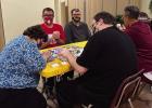 Several of the St. James ARC clients enjoy a game of Monopoly St. James ARC Clients Happy To Be Together Again