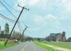 Leaning poles near Our Lady of Peace Church in Vacherie. Ida Tears Through And Tears Up St. James Parish