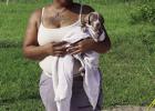 Shawanda Davis holds her puppy that fell into a sewer cleanout line. If you look at the base of this photo you will see a newly installed clean-out with the proper capping in place.