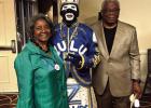 Dorthy and Gerald Harper take a photo with a member of the Zulu carnival club during the Harper family reunion. Harper Family Reunion: A Memorable Weekend Of Love & Laughter In NOLA