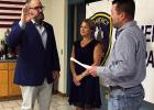 Newly elected Gramercy Police Chief Dustin Jenkins (left) joined by his wife Daniell, raises his right hand and recites the Oath of Office administerd by St. James Parish Clerk of Court Shane LeBlanc. Jenkins Takes Oath To Become New Gramercy Police Chief