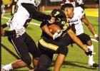 St. James Wildcat freshman wide receiver Shazz Preston, even after losing his helmet, battles for yards against De La Salle. Photo by Oliver Hooker Article Image Alt Text