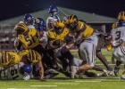 St. James ball carrier Xavier Johnson fights for yards last Thursday against St. Charles Catholic. Photo by Oliver Hooker