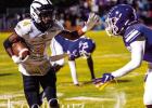 St. James Wildcat running back Kobe Brown prepares to stiff-arm a Woodlawn defender during last Friday’s 30-27 come from behind win. Photo by Oliver Hooker Wildcats Scratch and Claw Their Way Back To Beat Woodlawn