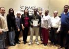 St. James Wildcat head football coach Lavanta Davis accepts a School Board Resolution that honors his team for finishing State Runner-up. Coach Davis thanked the Board for their support and several Board members shared how Coach Davis is a leader of men a