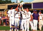 Bulldog freshman Marshall Louque (#11) steps on home plate and is met by teammates after belting a three-run homerun over the center field fence. Lutcher beat Kaplan 13-0. Photo by Tony Schexnayder Bulldogs Advance To Quarterfinals With Wins Over Kaplan