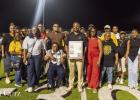 Dr. Duane Donald, joined by his family, accepts his St. James High School Hall of Fame plaque. Donald helped lead the Wildcats to back-to-back State Basketball titles in 1985 and 1986.