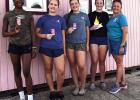 Simply Sweet Snoballs and Ice Cream, LLC co-owner Paula Roussel (far right) and several of her employees take a photo outside the snoball stand in Gramercy.
