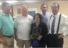 In photo, K.C. member Barry Weber (2nd from left) presents the Service Award to Pauline and her sons (from left) Larry, Jeff and David Faucheux. K.C. Honors Faucheux