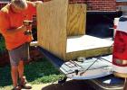 Tim Louque constructing a doghouse. Tim is a carpenter and he builds the doghouses from left over lumber and materials from completed jobs. Once complete, he delivers the doghouse to a pet owner/dog in need of shelter. Dog Lovers Casey And Tim Louque Have These Special Canines Happy To Be “In The Doghouse”