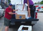 Alex Foret (standing in truck) donates his 4-H hog to Emery Forsythe and the local St. Vincent de Paul Food Bank. Foret’s hog produced roughly 200 lbs. of food for the needy. Youngsters Step Up In Time Of Crisis