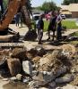 Lutcher Town workers bust up and dig up a section of Lionel Washington Street in order to reach a small puppy that managed to fall in a Town sewer clean-out pipe. Thankfully the dog was rescued, was uninjured, and only needed a good bath.